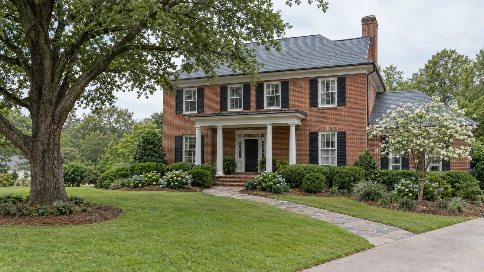 Daytime view of a front of a brick home before lighting